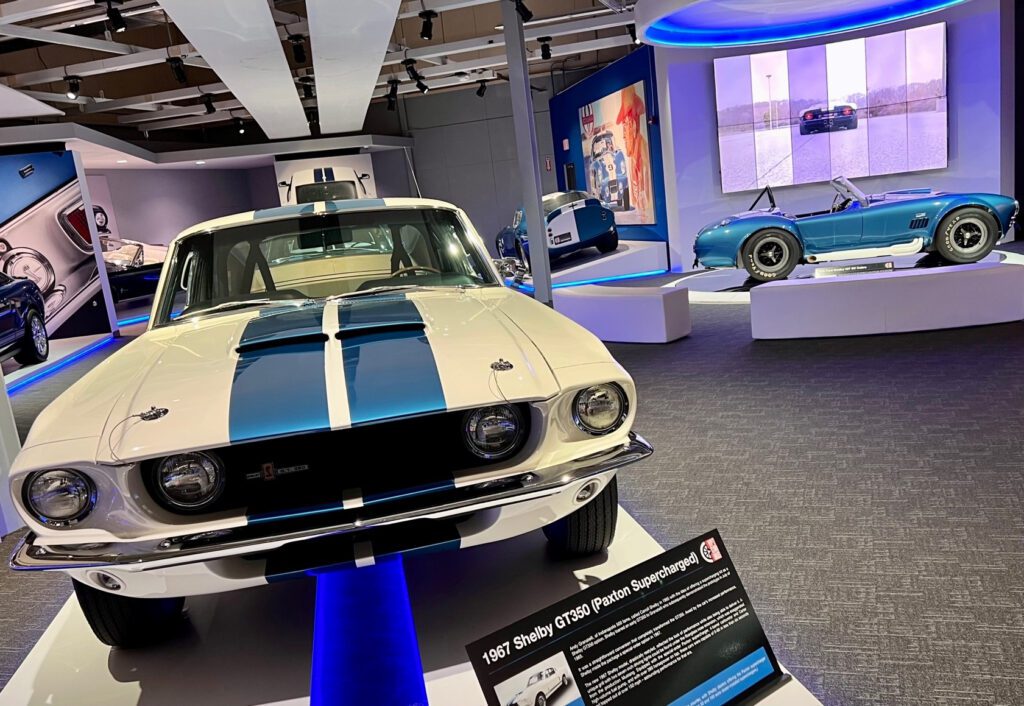 The ’67 Shelby GT350 Paxton Supercharged (foreground) and the 1965 Ford Shelby 427 SC Cobra are two of the rare cars in the Ford/Shelby Gallery at Newport Car Museum
