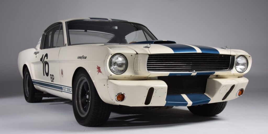 Front view of a classic white and blue-striped muscle car.