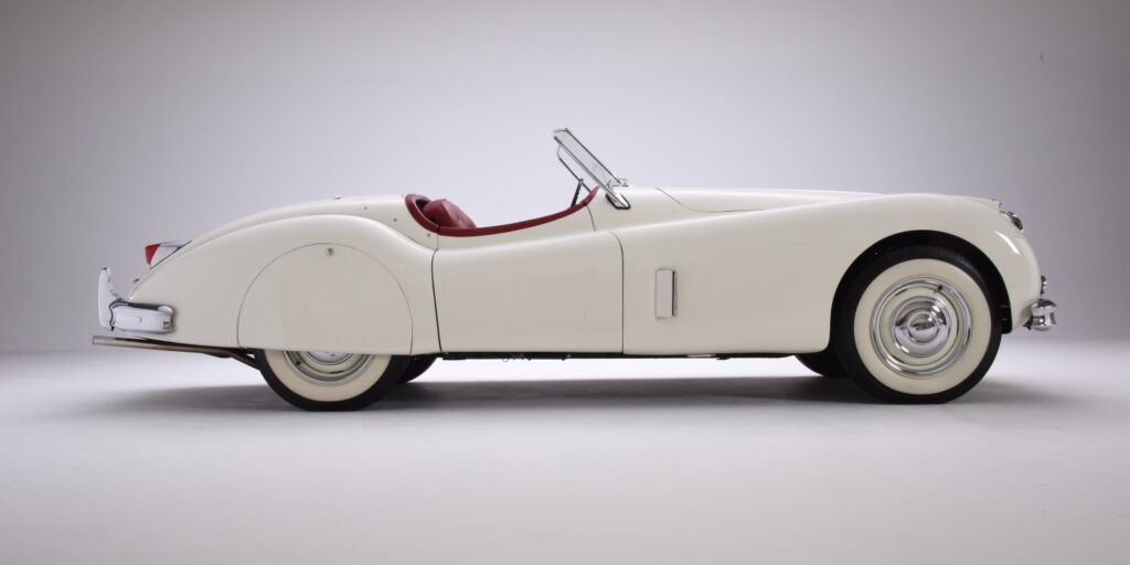 Classic white convertible car with red interior.