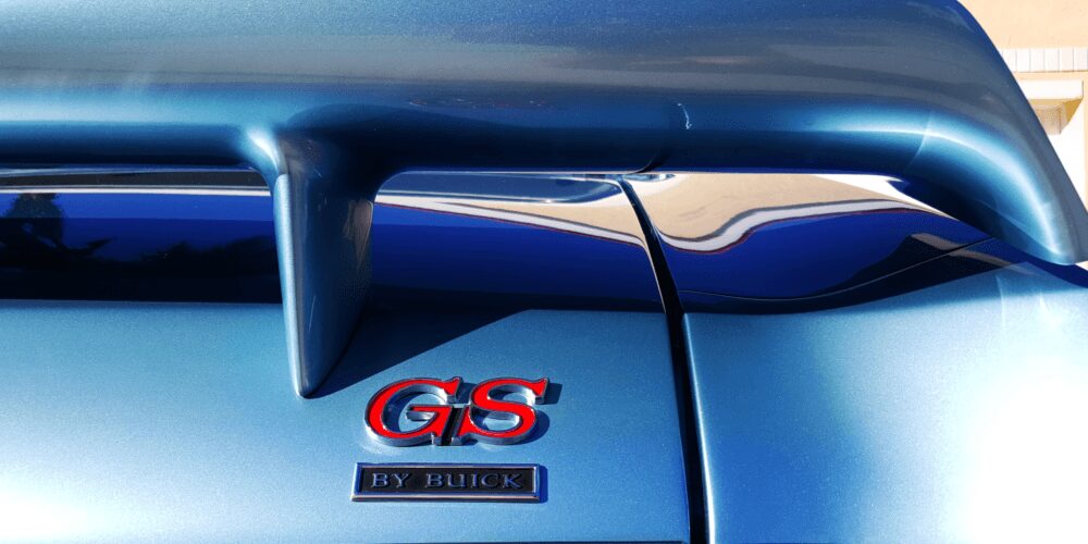 Close-up of a blue Buick GS emblem on a car.