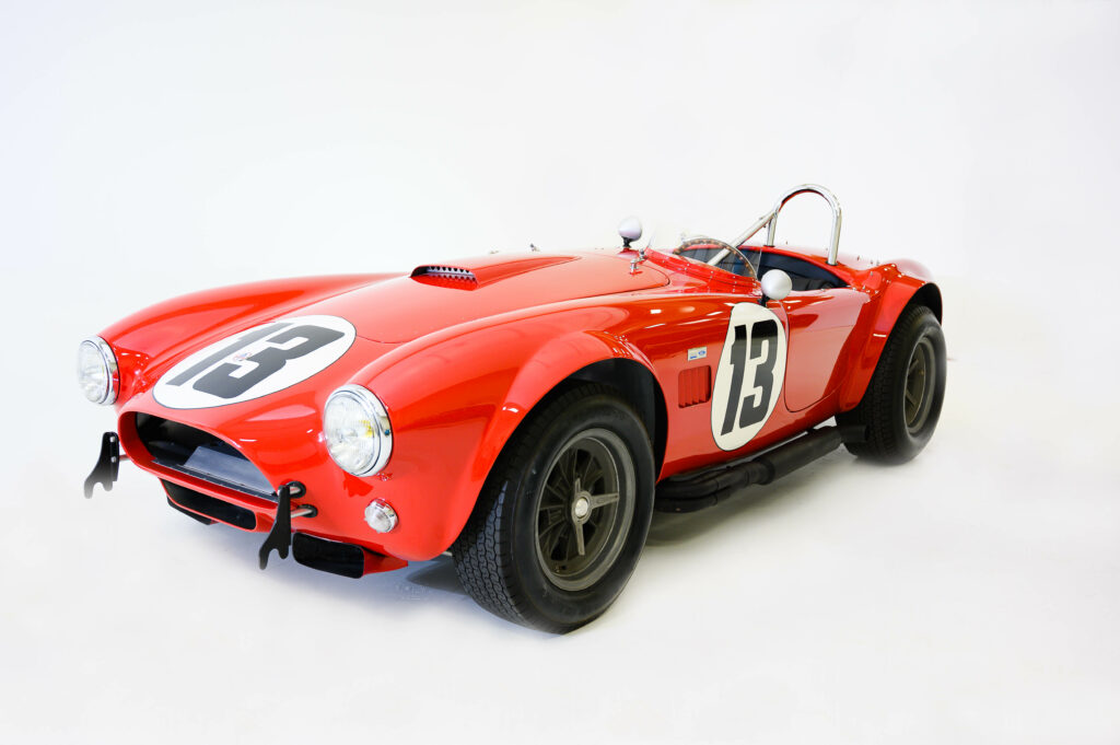Red classic race car with number 13 on the side.