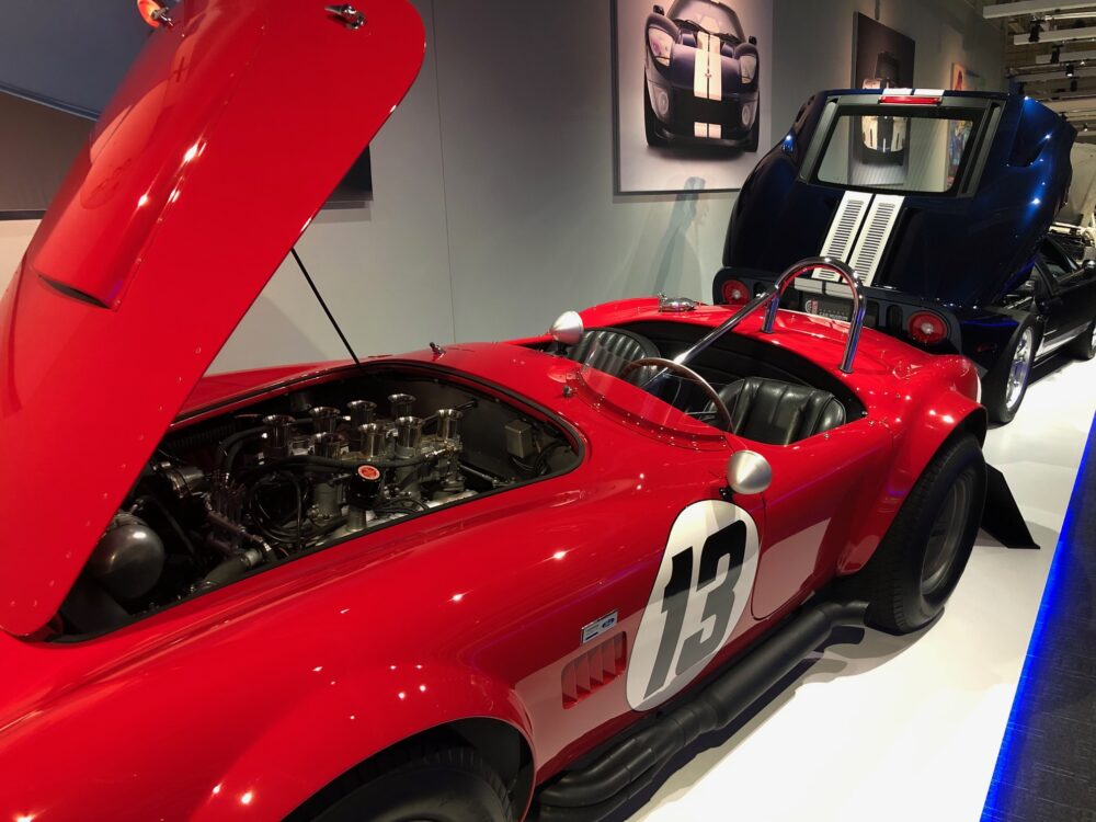 Red vintage race car with number 13 on display.