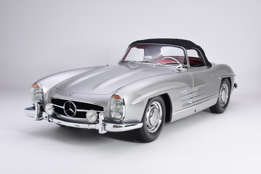 Classic silver Mercedes-Benz convertible with black soft top.