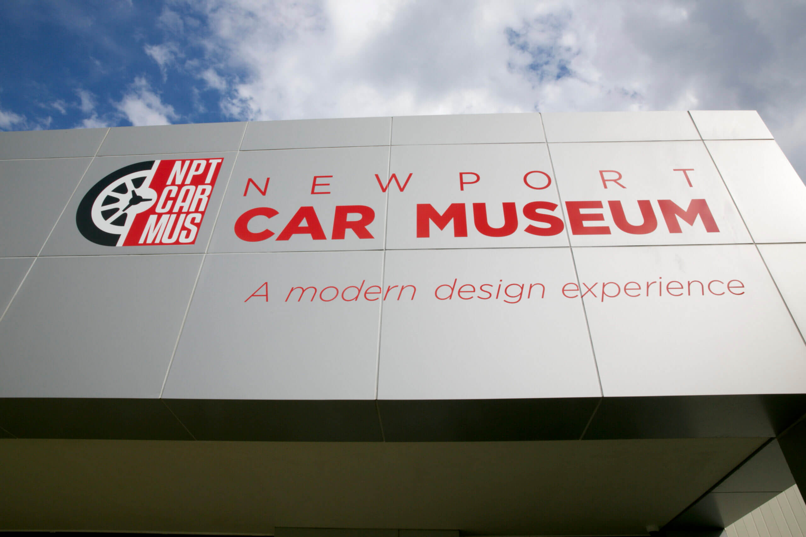 Signboard of Newport Car Museum with a modern design theme.