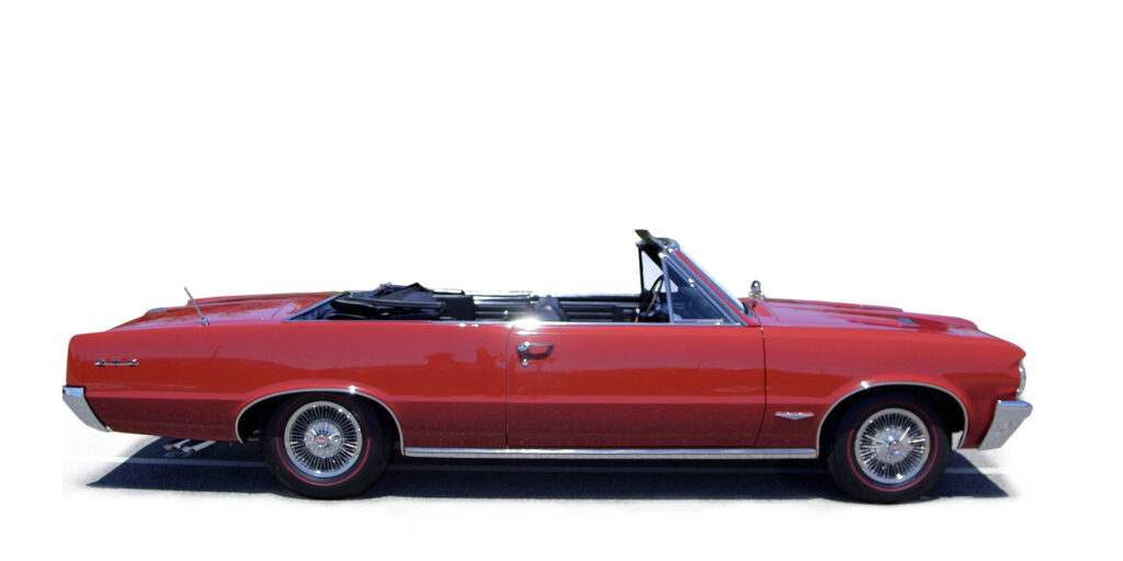 Classic red convertible car with its top down, isolated on white.