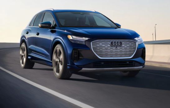 Blue Audi electric SUV driving on a road.