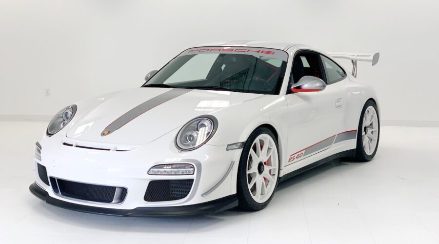 White Porsche sports car with racing stripes and red accents. White Porsche sports car with racing stripes and red accents.