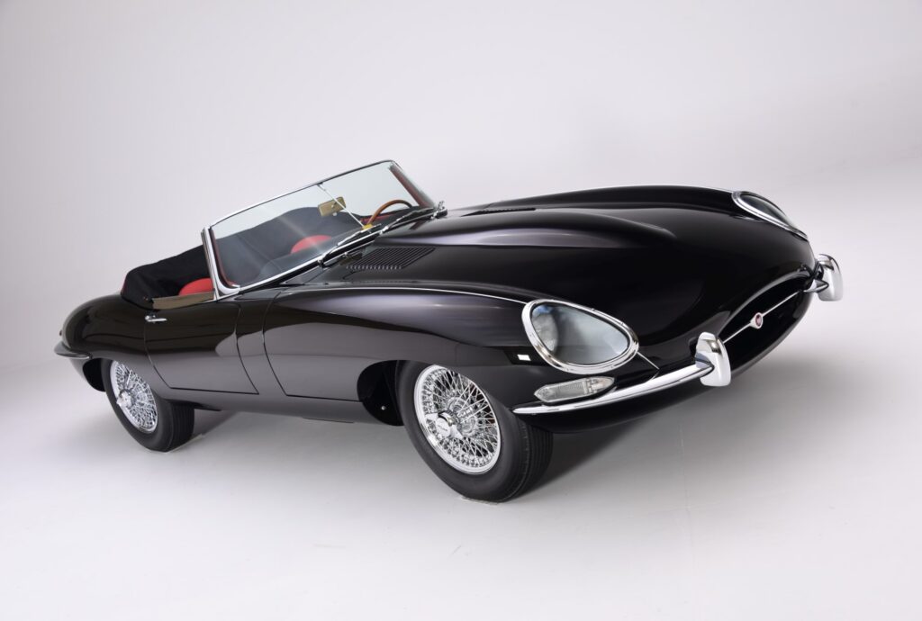 Classic black convertible sports car with sleek design and chrome detailing.