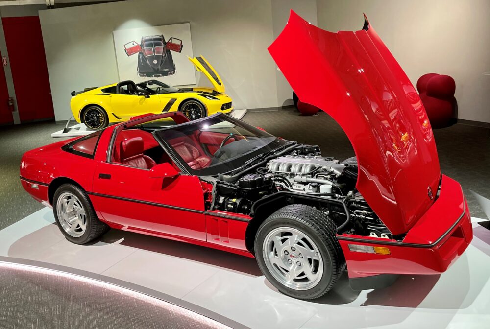 Red sports car model with open hood displaying engine details.