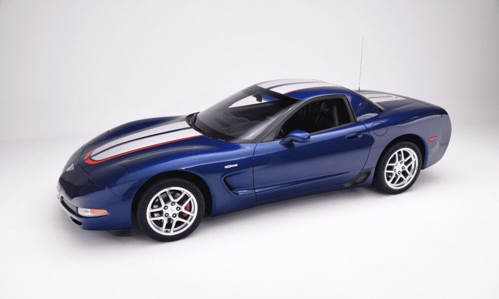 Blue sports car with racing stripes on a white background.
