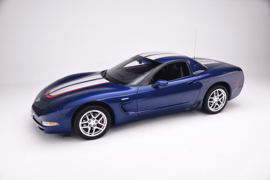 Blue sports car with racing stripes on a white background.