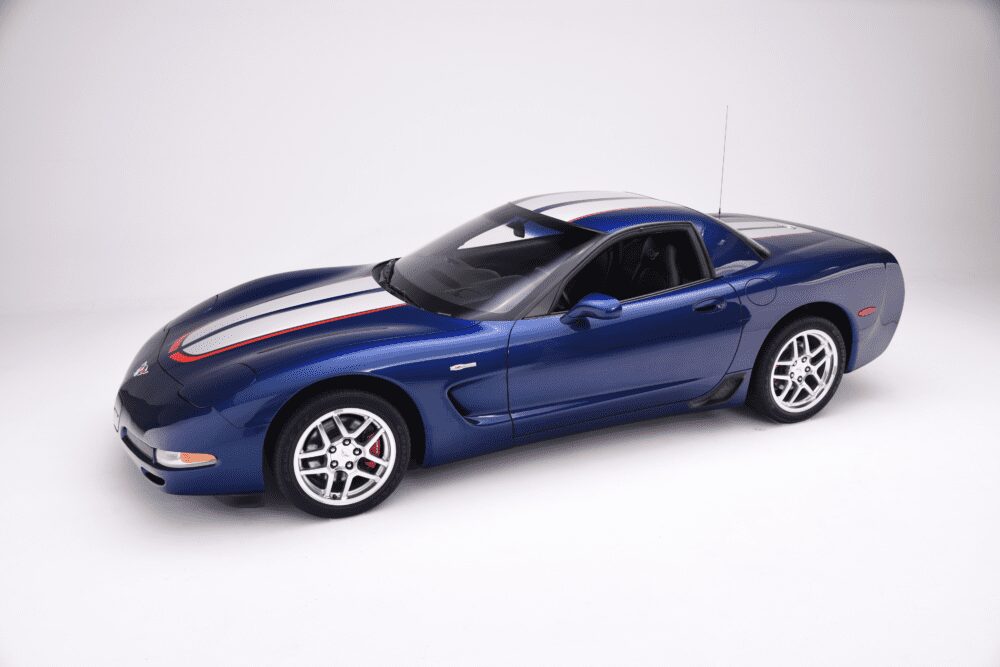 Blue sports car with racing stripes on a white background.