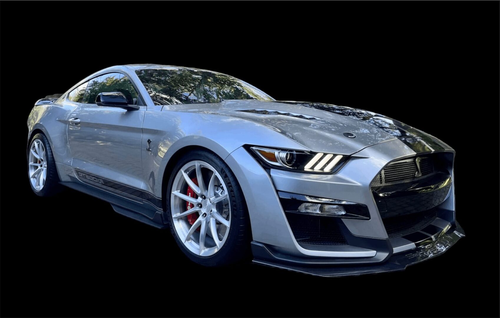 Sleek gray sports car with aggressive front design and red brake calipers.