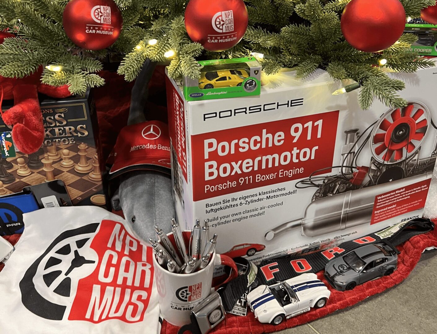 Porsche 911 Boxer engine model kit with accessories and memorabilia.