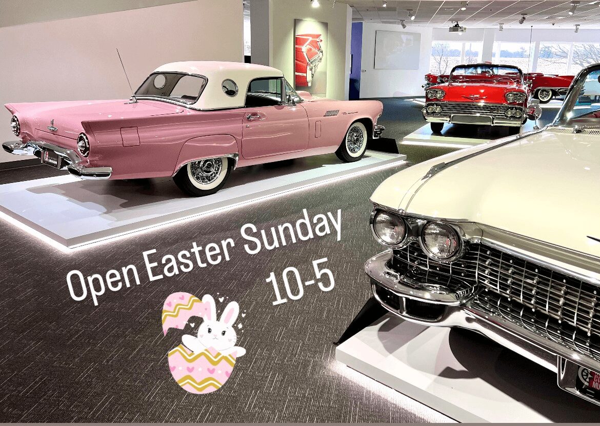 Classic cars displayed in a bright showroom with Easter decorations.
