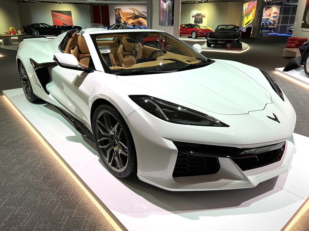 White convertible sports car with tan interior on display indoors. White convertible sports car with tan interior on display indoors.
