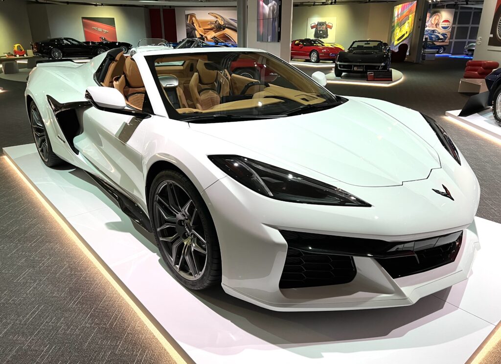 Sleek white convertible sports car with tan leather interior on display.