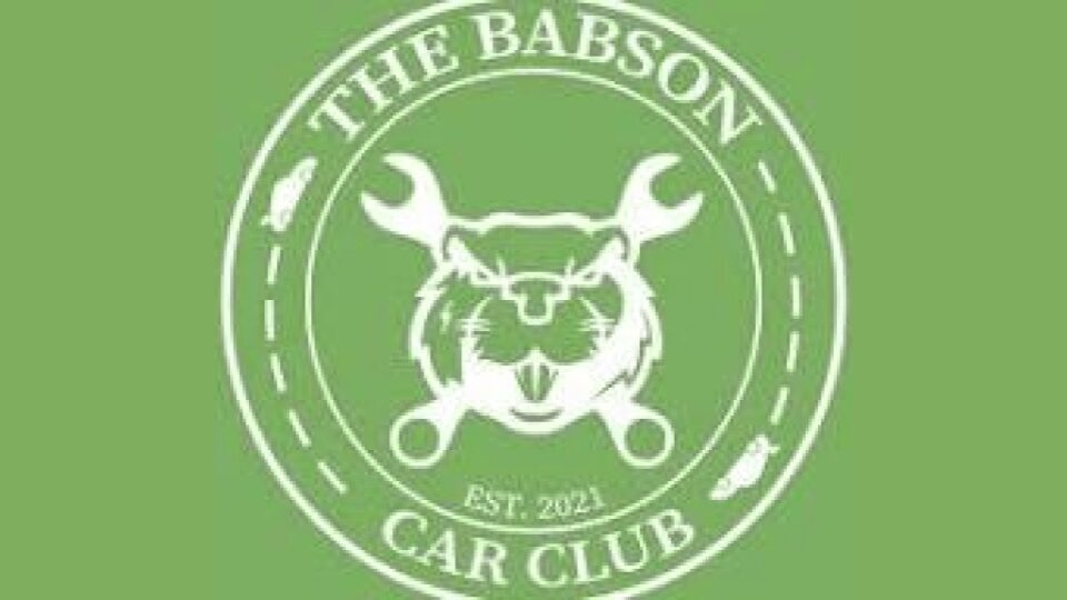 Logo of The Babson Car Club featuring a fierce wildcat and wrenches.
