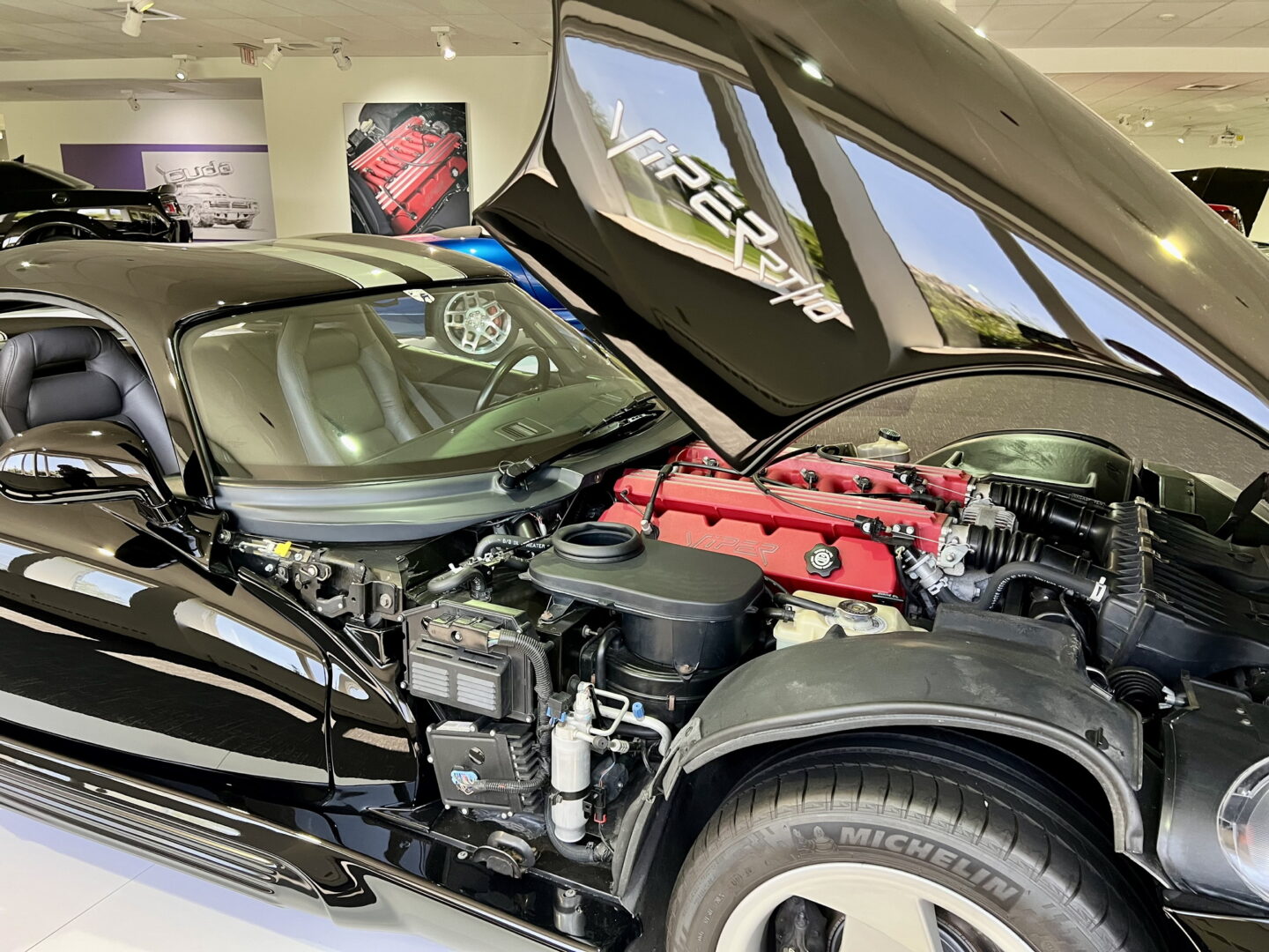 Close-up of a car engine under the open hood.