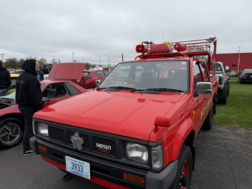 Red Datsun pickup with emergency lights